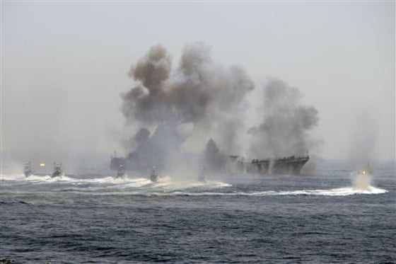 Iran's elite Revolutionary Guard on Thursday started large-scale war games, seen left, in strategic waterways, state TV reported.